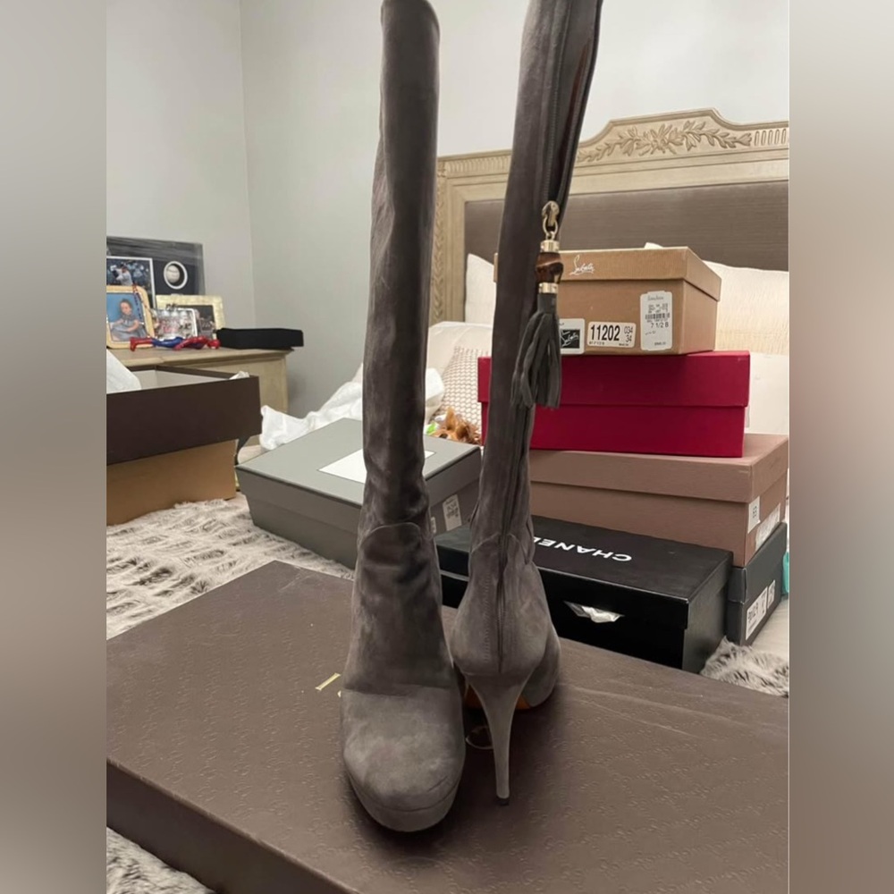Charcoal gray GUCCI suede boots with a heel.